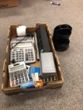 Office supplies, calculator, hole punch and post it