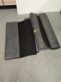 Several rolls of long rugs