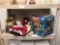 Shelf contents includes Mr. Christmas holiday merry go round wooden bear hunter Santa Claus and two