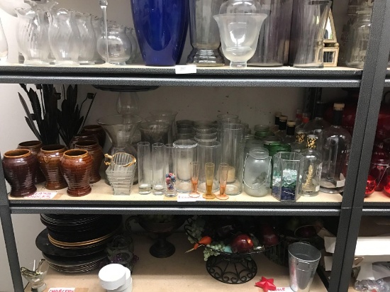 Shelf of decorative vases candleholders and stands