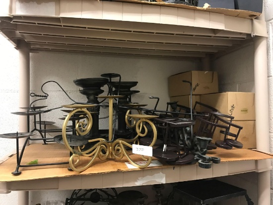 Two shelves of candleholders and candles
