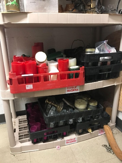 Two shelves of candles and candle holders