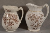 2 Brown & White Transferware Pitchers. Largest is 7 1/2