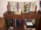 Assorted books on shelf and in box