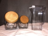 (2) Glass Sugar Jars w/ Wood Lids & (1) Plastic Carafe.