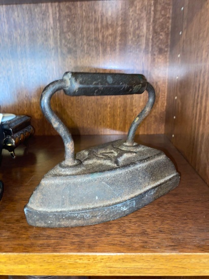 Old steal iron heated by wood stove. This iron was made by W.H Howell Company in Geneva ILL. W.H.