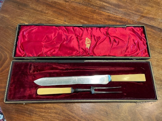 Boxed carving knife and fork, celluloid handles, unmatched, hinge broken on box.