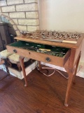 Two drawer table containing a collection of celluloid handled flatware, made by...Walker & Hall.