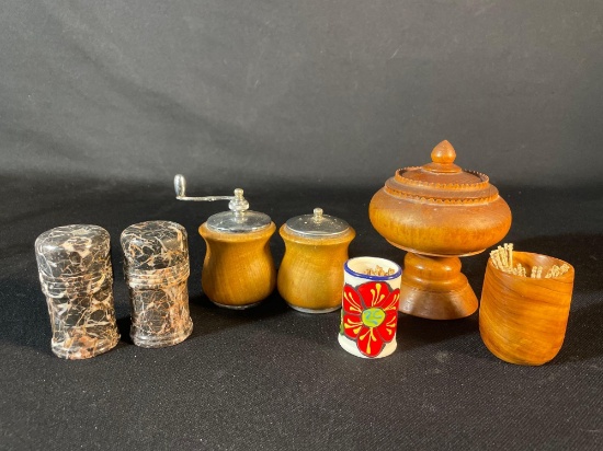 salt and pepper shakers, along with a toothpick holder and a small container with a lid.