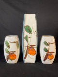 three hand-painted Japanese porcelain vases. The vases are decorated with a stylized persimmon fr...