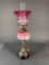 Cased pink font, cranberry shade lamp