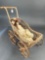 Wicker doll buggy with bisque head antique doll