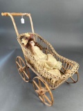 Wicker doll buggy with bisque head antique doll