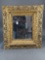 Heavily carved gold frame with mirror