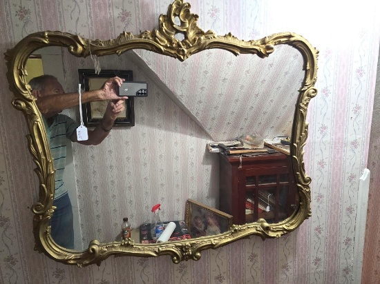 Large gold framed styled mirror