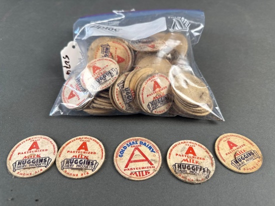 Sack of Huggins paper milk bottle tops, maybe 50 tops