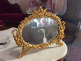 Oval cherub beveled mirror,