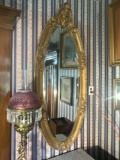 Heavily carved gold frame entry mirror with cherubs