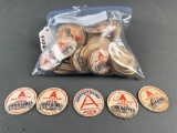 Sack of Huggins paper milk bottle tops, maybe 50 tops