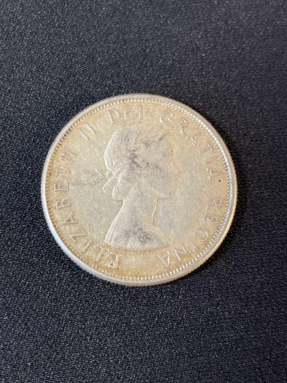 1958 British One Shilling coin featuring a portrait of Queen Elizabeth II on the obverse side