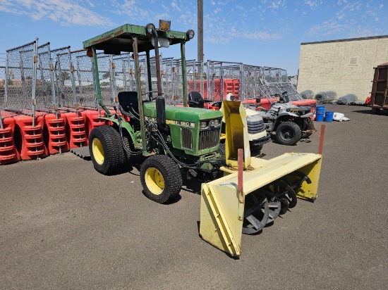 John Deere 650 compact utility tractor 4x4 equipped with a front-mounted snowblower.