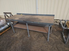 heavy-duty industrial steel-frame workbench with a lower shelf for storage