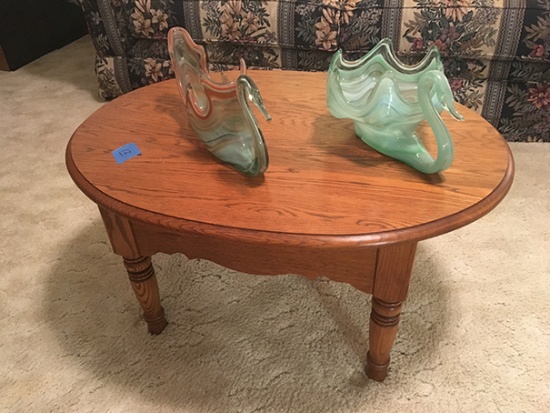Oak 24" oval table and (2) blown glass swans