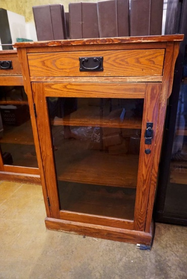 Glass front display cabinet with drawer