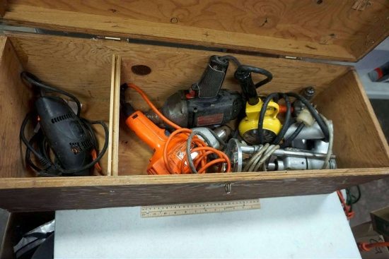 Wooden toolbox full of power tools, power, drills, and more.