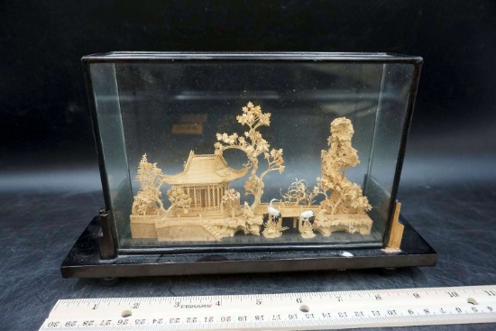 Oriental carving under glass.
