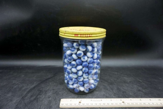 Jar of blue marbles.