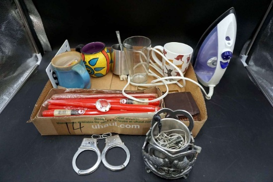 Handcuffs, headphones, cups, iron, candle.