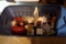 Large tote of Christmas decor, figurines, Santa, stockings, candles, snowmen, gifts.