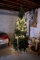 Tall faux Christmas tree, pre lit, some lights working.