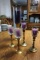 Five brass candle sticks with purple candles.
