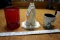 Red glass, coffee mug with spoon, praying hands.