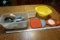 Assorted tupperwares, lids, strainer, kitchen utensils.