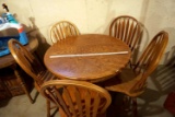 Round pedestal table and five chairs. Unique wood grain pattern. The pedestal base is currently sitt