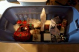Large tote of Christmas decor, figurines, Santa, stockings, candles, snowmen, gifts.