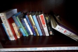Assorted books, binders, clipboard.