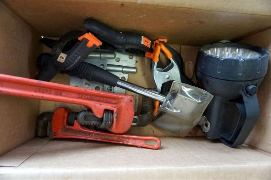 Assorted tools, flashlight, monkey wrenches, axe, hinges.