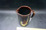 Brown glazed stoneware pitcher.