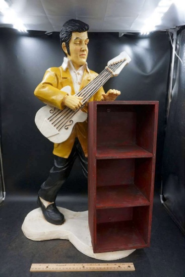 Elvis statue with shelf.
