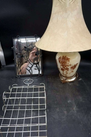 Lamp, candle holder, mirror, shelf.