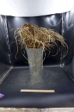 Vase with grass filler.