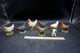 Collection of ceramic chickens, one happy cow.