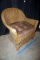 Wicker chair with cushion.