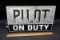 Pilot on duty metal sign.