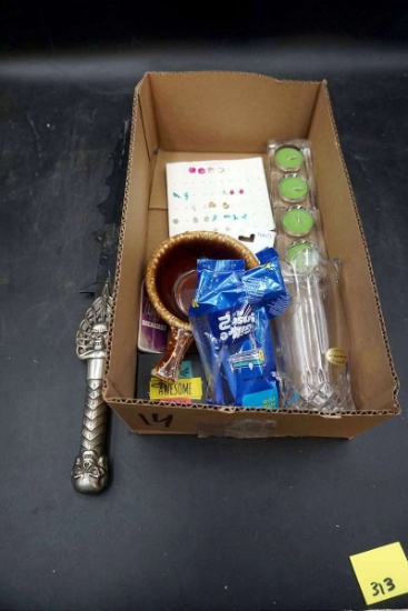 Decorative dagger, candles, earrings, glassware.