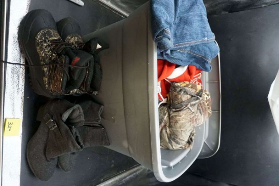 Tote full of clothing, work boots, Huskers gear, camouflage, and more.